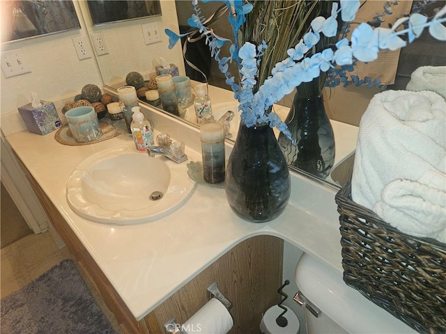 bathroom featuring vanity and toilet