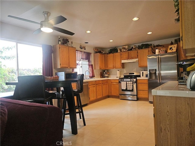 kitchen featuring sink, plenty of natural light, ceiling fan, and appliances with stainless steel finishes