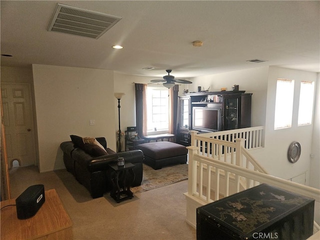 living room featuring ceiling fan and light colored carpet