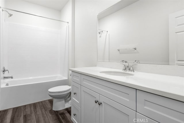 full bathroom with hardwood / wood-style flooring, vanity, toilet, and shower / bathing tub combination