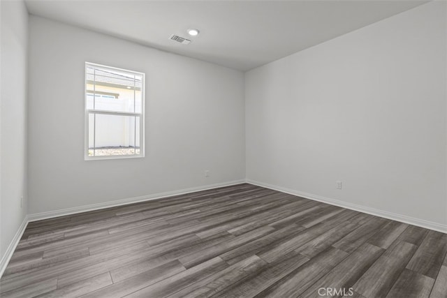 empty room with hardwood / wood-style floors