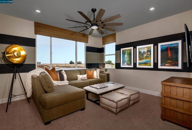 carpeted living room with ceiling fan