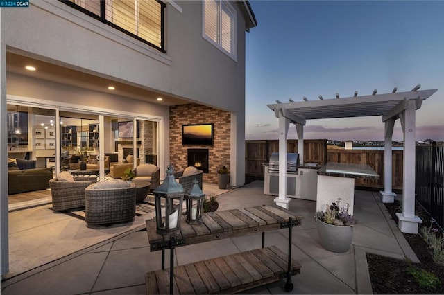 patio terrace at dusk featuring exterior kitchen, area for grilling, outdoor lounge area, and a pergola