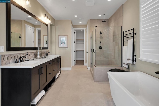 bathroom with vanity and independent shower and bath