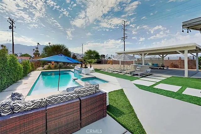 view of pool with a mountain view, a patio area, and an in ground hot tub