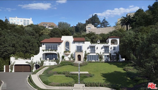 mediterranean / spanish-style house with a garage and a front lawn