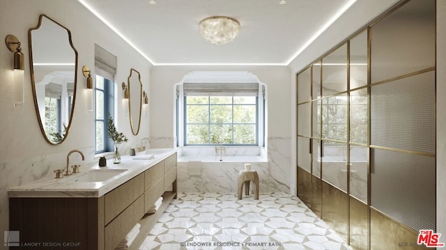 bathroom featuring tile patterned flooring, vanity, and tiled tub