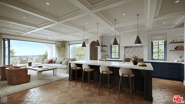 kitchen with decorative light fixtures, a healthy amount of sunlight, a spacious island, and a breakfast bar area