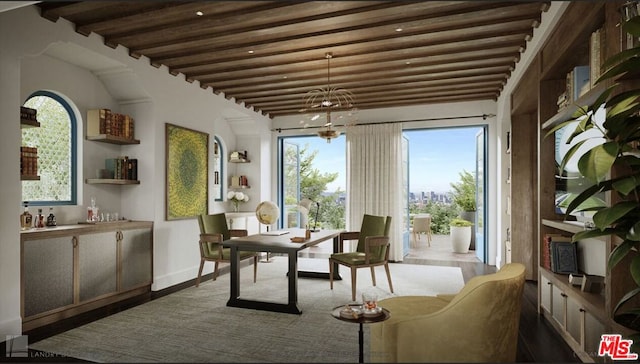 sunroom / solarium with beam ceiling and an inviting chandelier