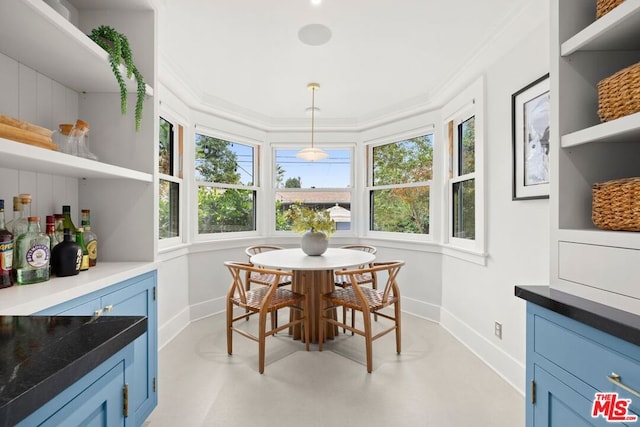 dining space featuring crown molding