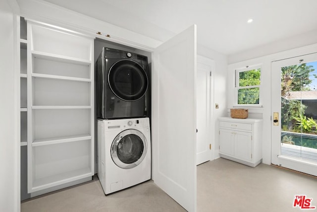 clothes washing area with stacked washer and clothes dryer