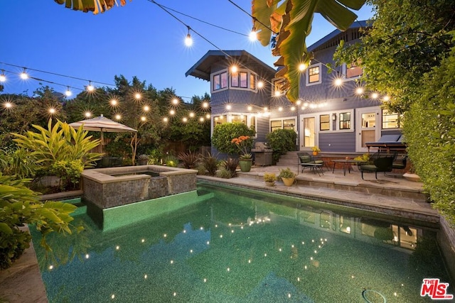 view of pool featuring an in ground hot tub and a patio