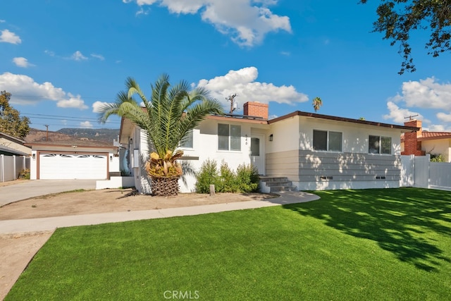 view of front of property with a front lawn and a garage