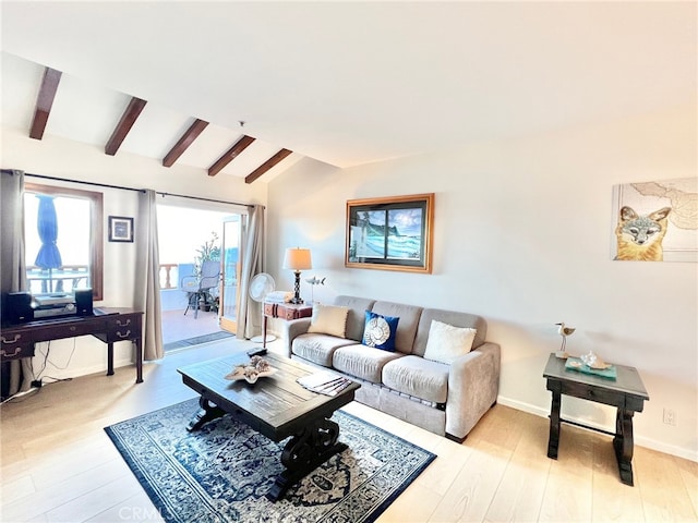 living room with light hardwood / wood-style flooring and vaulted ceiling with beams