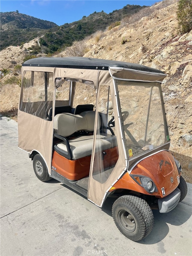 view of vehicle parking with a mountain view