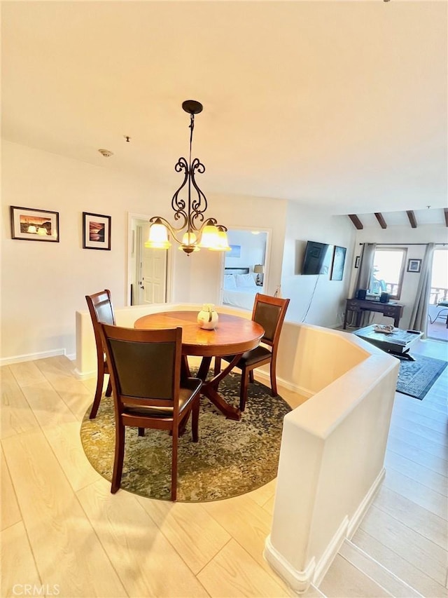 36 Camino De Flores Unit 69, Avalon, CA 90704 - dining room with light wood-style floors, a chandelier, and baseboards