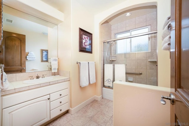 bathroom with vanity, an enclosed shower, and tile patterned floors