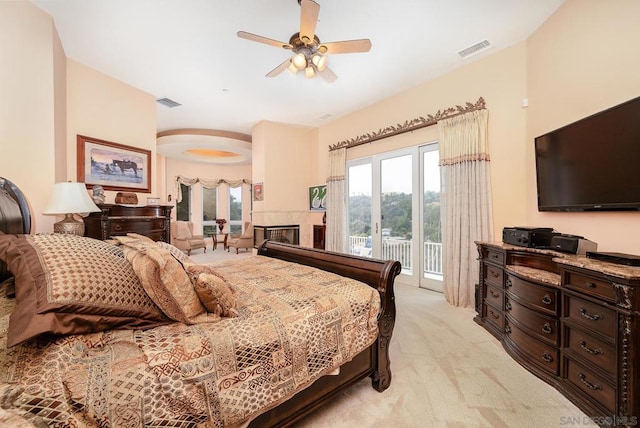 bedroom with light carpet, access to exterior, and ceiling fan