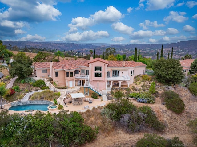 birds eye view of property featuring a mountain view