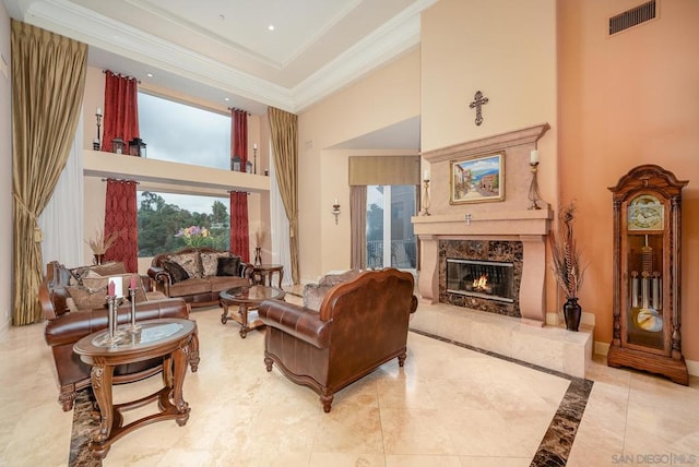 tiled living room with a towering ceiling, ornamental molding, and a fireplace