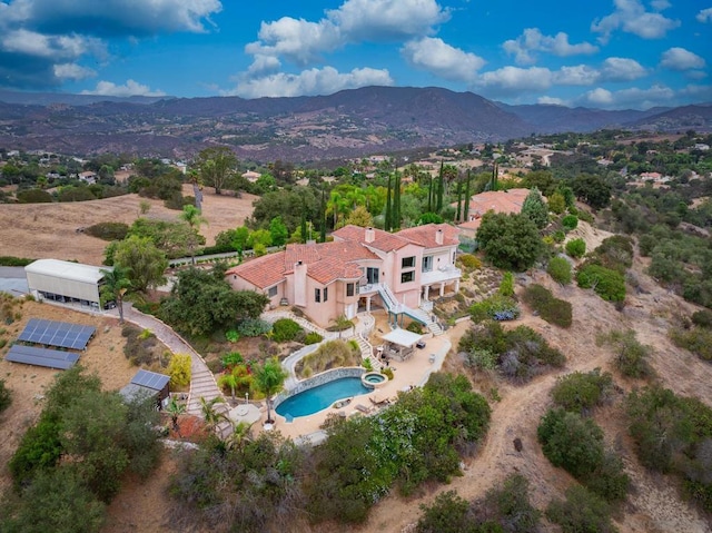 birds eye view of property with a mountain view