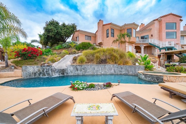 view of swimming pool with a patio and pool water feature