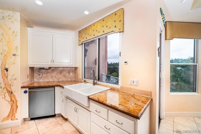 kitchen with white cabinets, stainless steel dishwasher, and plenty of natural light