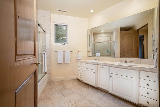 bathroom with vanity, combined bath / shower with glass door, and tile patterned floors