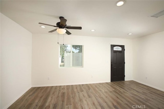 unfurnished room with ceiling fan and dark hardwood / wood-style flooring