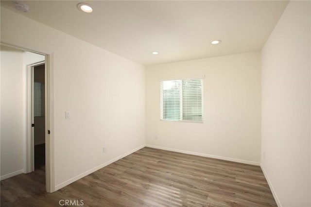 spare room with dark wood-type flooring