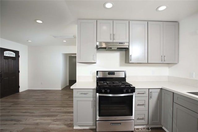 kitchen with gray cabinets, gas stove, and dark wood-type flooring