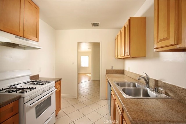 kitchen featuring white range with gas cooktop, dishwasher, sink, and light tile patterned floors