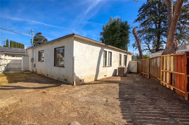 view of side of home with central air condition unit