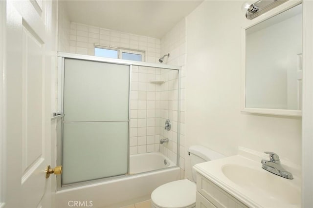 full bathroom with shower / bath combination with glass door, vanity, and toilet