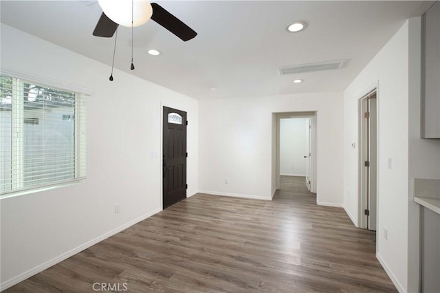 spare room featuring dark hardwood / wood-style floors and ceiling fan