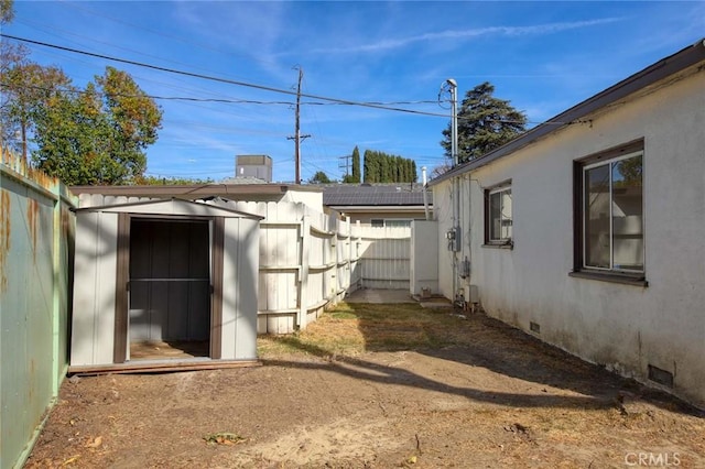 view of side of property featuring a storage unit