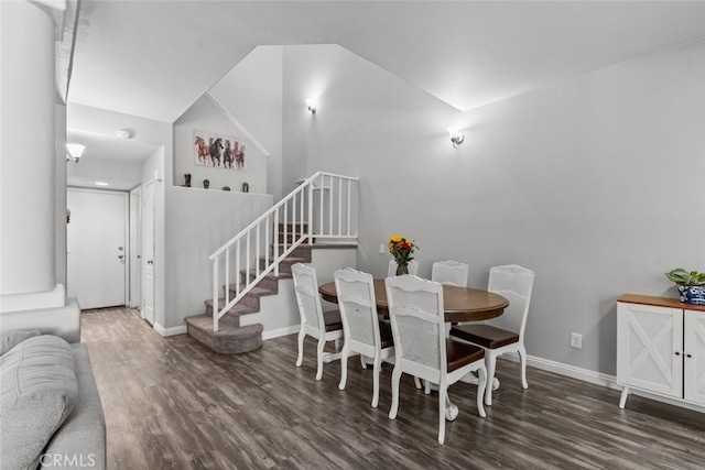 dining room with dark hardwood / wood-style floors and high vaulted ceiling