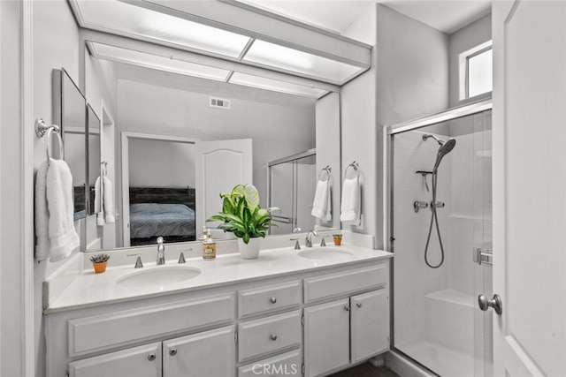 bathroom featuring vanity and an enclosed shower