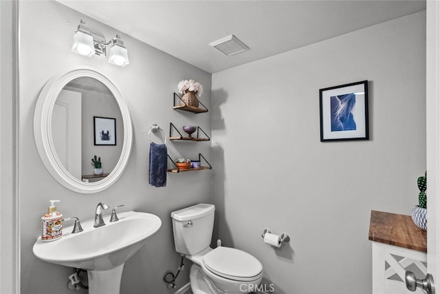 bathroom with toilet and sink