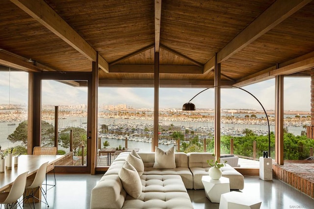 sunroom / solarium with wood ceiling and a water view