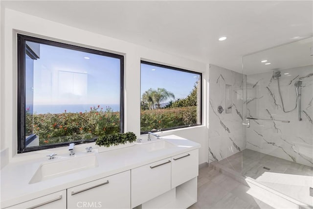 bathroom featuring vanity and tiled shower