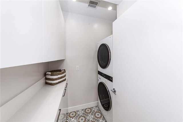 laundry room with stacked washer and clothes dryer