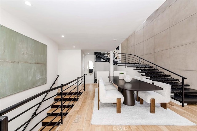 staircase with hardwood / wood-style flooring and tile walls