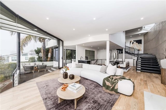 living room with expansive windows and light wood-type flooring