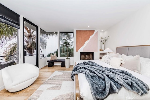 bedroom featuring access to outside and light wood-type flooring