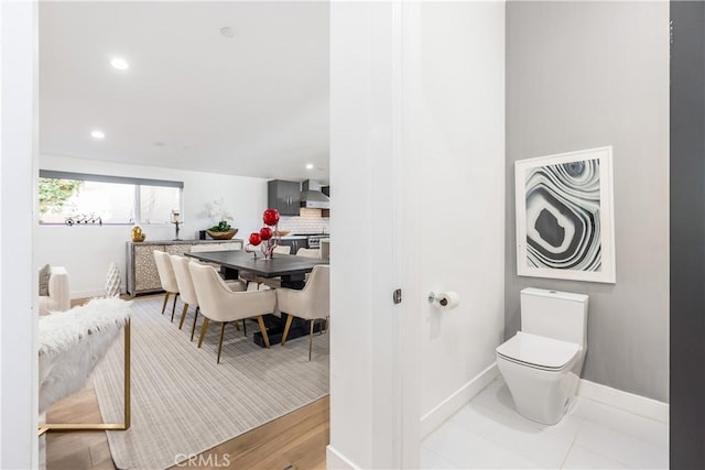 bathroom with backsplash and toilet