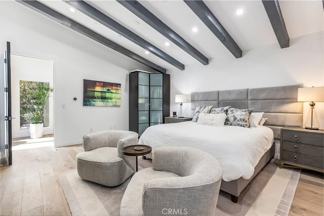 bedroom featuring light hardwood / wood-style flooring and lofted ceiling with beams