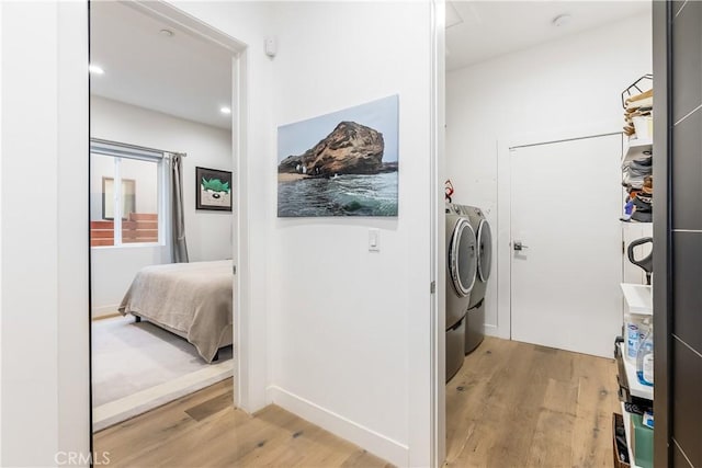 laundry room featuring light hardwood / wood-style floors and independent washer and dryer