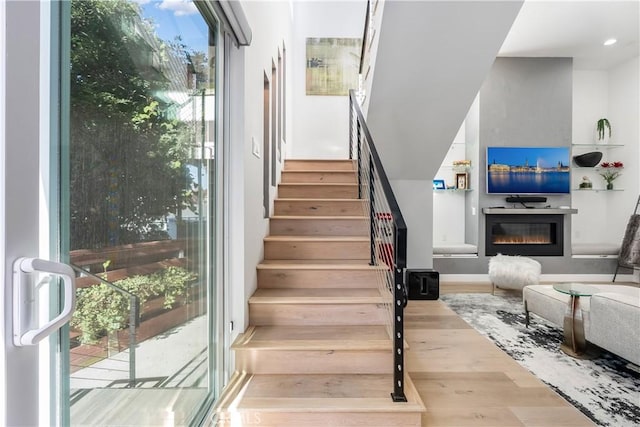 stairway with hardwood / wood-style flooring