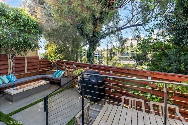 wooden terrace featuring a fire pit